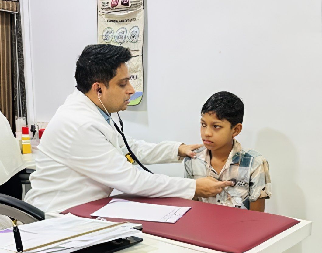 Dr. Sunildatt listens to a boy’s chest at the children’s clinic