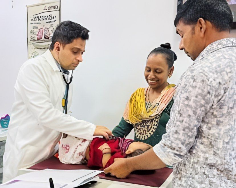 Dr. Sunildatt examines a baby as both parents look on